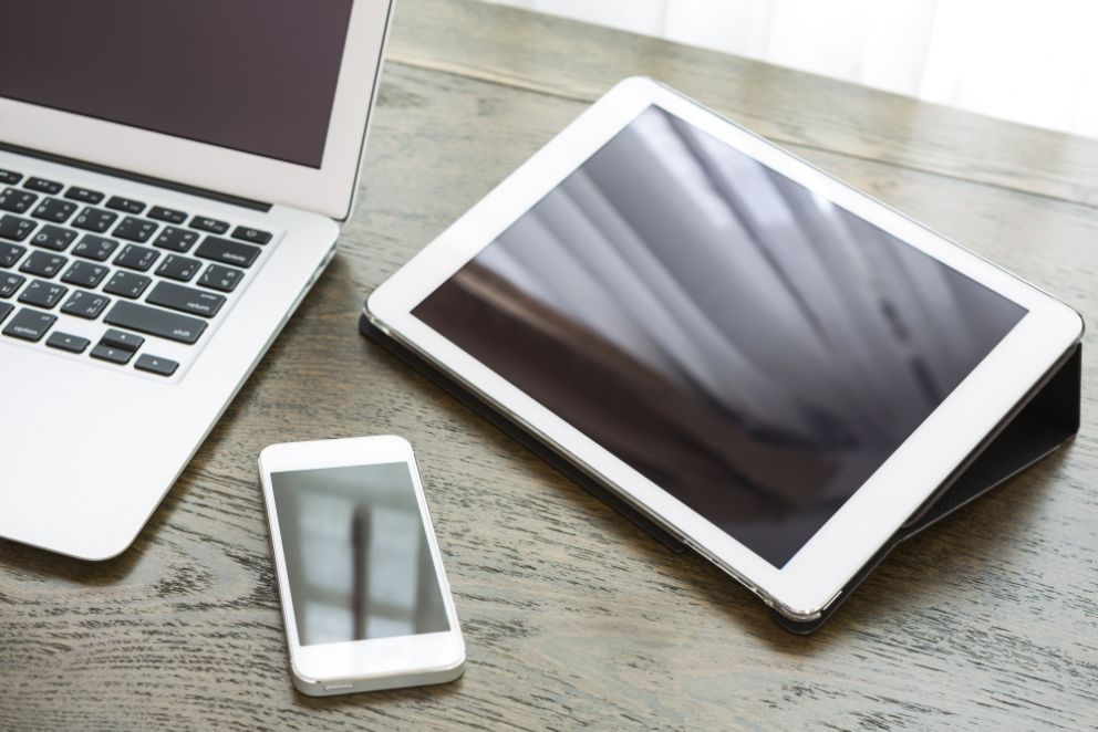 close up technological devices wooden desk